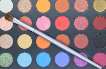 Makeup palette closeup with brush