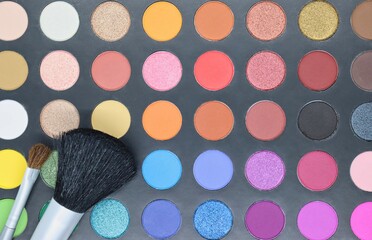 Makeup palette closeup with brushes