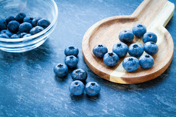 Blueberries on a wooden table. Fresh berries. Wild blueberries on a wooden stand.