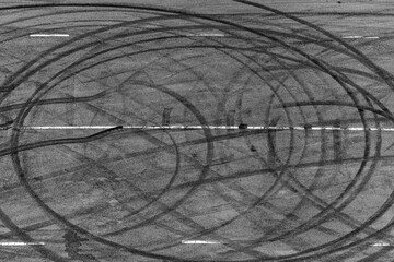 Top view tire tracks texture and background, Asphalt texture with line and tire marks, Automobile automotive tire skid mark on race track, Abstract texture car drift tire skid mark.