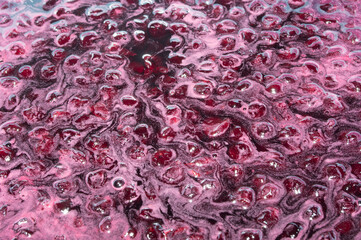 The texture is food-grade. Berries in the process of cooking cherry jam.