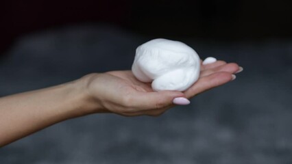 Hair foam, hands apply balloon foam, hair styling product, close-up, women's hands