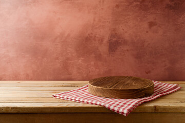 Empty podium on wooden table with tablecloth over rustic wall  background. Kitchen interior mock up...