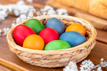 Fototapeta na wymiar Easter eggs, dyed hen eggs in a wicker basket bowl
