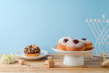 Traditional donuts for Hanukkah holiday celebration on wooden table