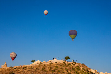 view of the valley of Cappadocia in the early morning with hot air balloons. View from above