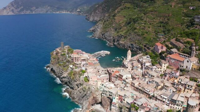 Vernazza village with typical colorful multicolored buildings houses, Castello Doria castle on rock, green hills and Genoa Gulf, Ligurian Sea, National park Cinque Terre