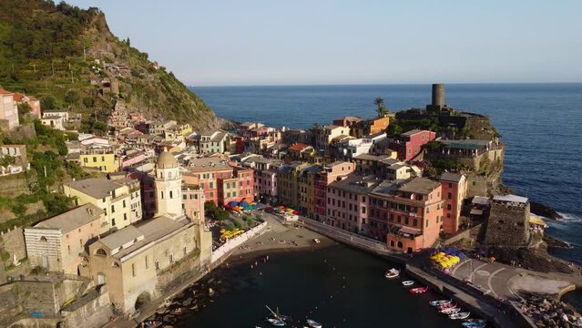 Vernazza village with typical colorful multicolored buildings houses, Castello Doria castle on rock, green hills and Genoa Gulf, Ligurian Sea, National park Cinque Terre