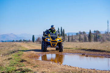 Girl driving ATV on dirt road © Addy
