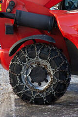 wheel with snow chains on red vehicle