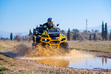 Girl driving ATV on dirt road © Addy