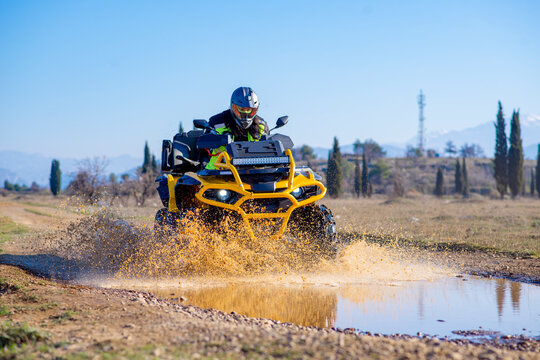 Girl driving ATV on dirt road