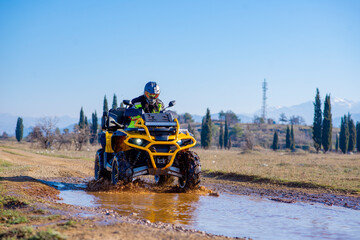 Fototapeta premium Girl driving ATV on dirt road