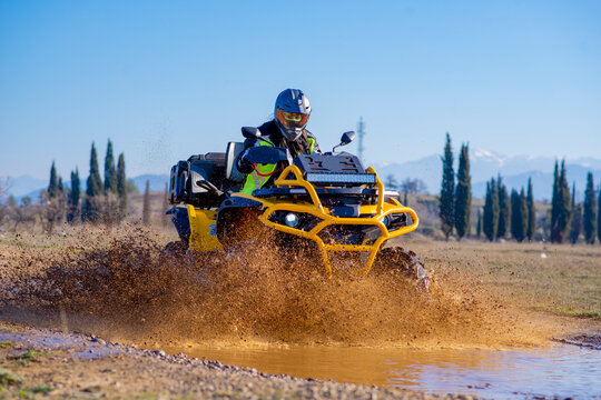 Girl driving ATV on dirt road