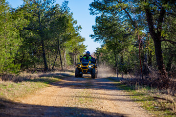 Girl driving ATV on dirt road