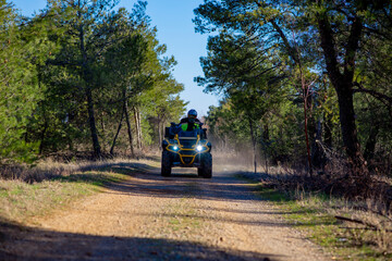 Girl driving ATV on dirt road © Addy