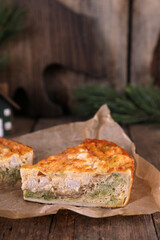 Quiche with chicken and broccoli on a wooden table