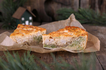 Quiche with chicken and broccoli on a wooden table
