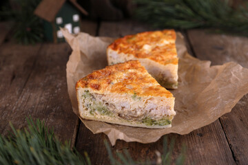 Quiche with chicken and broccoli on a wooden table