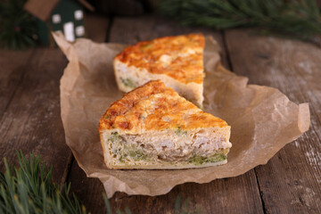 Quiche with chicken and broccoli on a wooden table