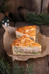 Quiche with chicken and broccoli on a wooden table