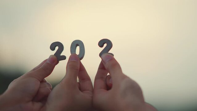 Happy New Year 2023, Hands of people's holding 2023 number in morning. Diverse friends congratulate new year.