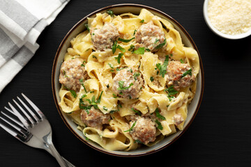 Homemade One-Pot Swedish Meatball Pasta in a Bowl on a black background, top view. Flat lay, overhead, from above.