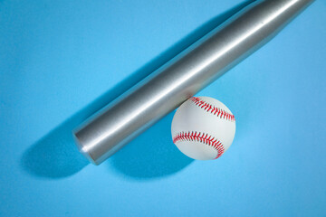 Baseball bat and baseball on the blue background.