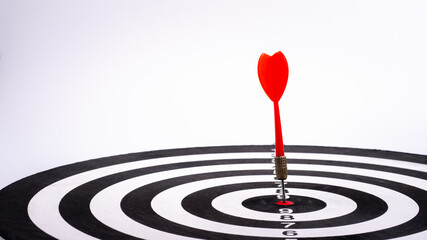 Bullseye is a target of business. Dart is an opportunity and Dartboard is the target and goal. Dart on center bullseye represent a challenge in success business marketing as concept.