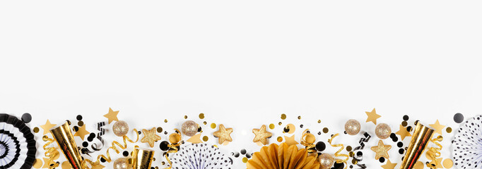 New Years Eve bottom border of gold and black confetti, noisemakers, streamers and decorations. Top...