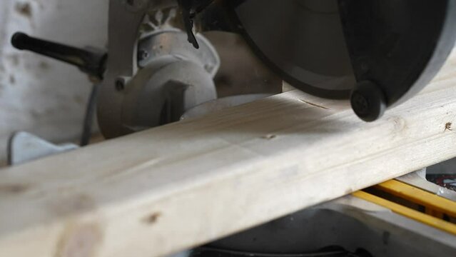 Slow Motion mitre saw cutting wood