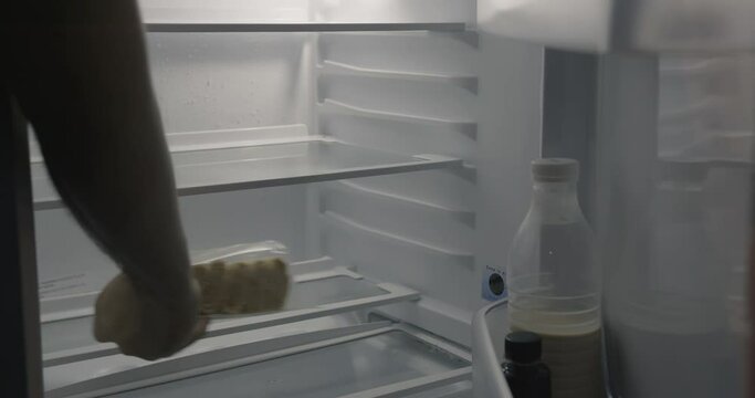 The empty refrigerator opens. Small refrigerator with a semi-finished product.