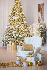 Interior of luxury interior with fireplace, comfortable sofa and chandelier decorated with Christmas tree and gifts