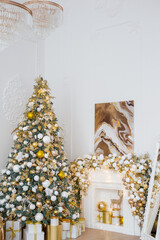 Interior of luxury interior with fireplace, comfortable sofa and chandelier decorated with Christmas tree and gifts