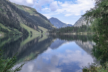 Naklejka na ściany i meble Schwarzensee mountain lake in Solktaler Nature Park, Kleinsolker Obertal, the largest lake in the Niedere Tauren, Scladming, Styria, Austria