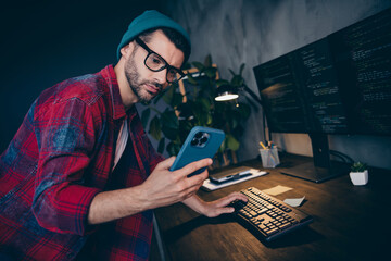 Photo of smart ponder guy dressed eyewear watching working apple samsung modern device indoors workstation workshop home