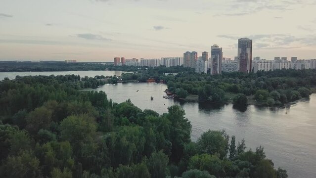 A green district of city with parks, river and high-rise residential buildings.