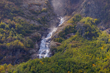 Tana glacier in North Ossetia, mountain waterfalls in the highlands.
