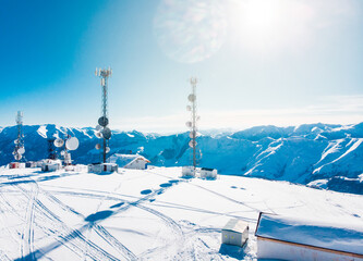 Gudauri ski chairlifts in clouds with signal antennas in background under mist and clouds