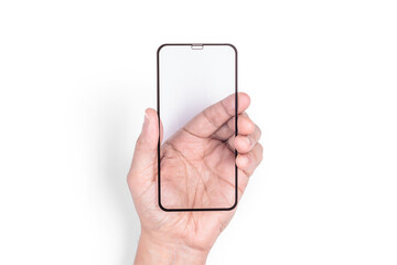 The hand holds a protective screen for a mobile phone. White background. Close-up.