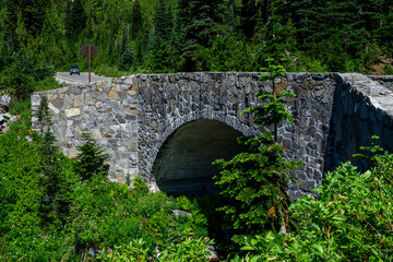 Fototapeta na wymiar Historic Paradise River Bridge, stone bridge on Paradise Valley Road in Mt. Rainier National Park, WA on a beautiful summer day 