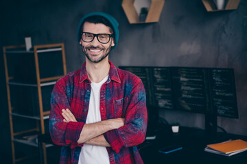 Photo of positive smiling programmer wear spectacles having work done arms folded indoors workplace...