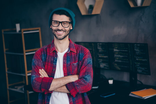Photo of positive smiling programmer wear spectacles having work done arms folded indoors workplace workshop home