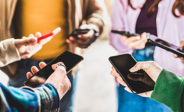 Closeup of people hands using data on mobile smart phones - Detail of web users sharing images on social media with smartphones - Tech and cellphone culture concept with selective focus on right thumb