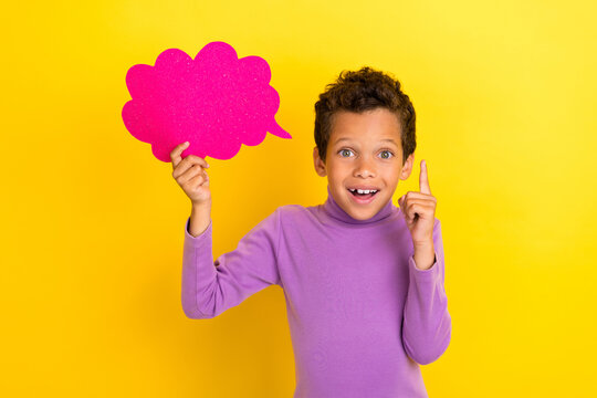Photo of creative inspired small boy hold paper cloud card point finger brilliant isolated on yellow color background