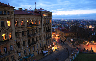 Old town streets at night. Night city lights. Car headlights on the night street. Cars and traffic...