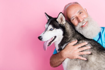 Portrait of veterinarian advertise high quality care for pets hug siberian husky isolated on pastel...