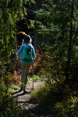 A girl is hiking on a trail in the mountains