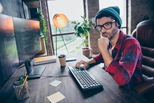 Photo of cool intelligent guy dressed eyewear arm chin creating new start up modern device indoors workstation workshop home