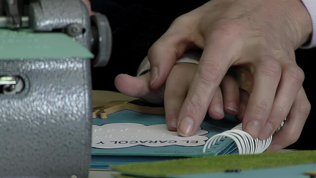 Hands of a Kid and Teacher  While Reading Braille Code with the Word "The Snail" (Spanish: "El Caracol) at Classroom of a School for the Blind in Argentina. 4K Resolution.